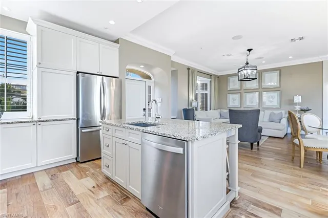 a kitchen with kitchen island a sink stove and refrigerator