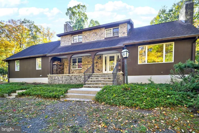 a front view of a house with a garden and yard