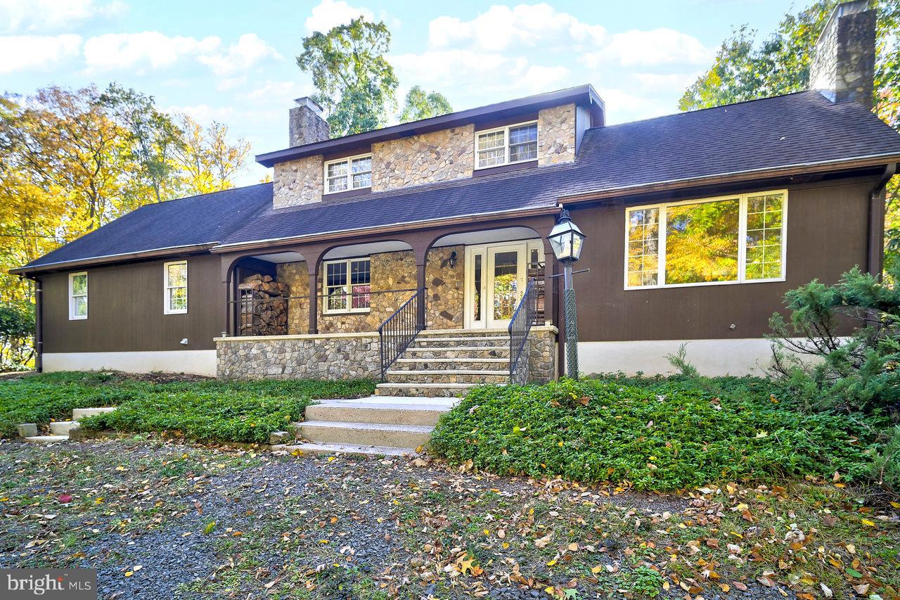 a front view of a house with a garden and yard
