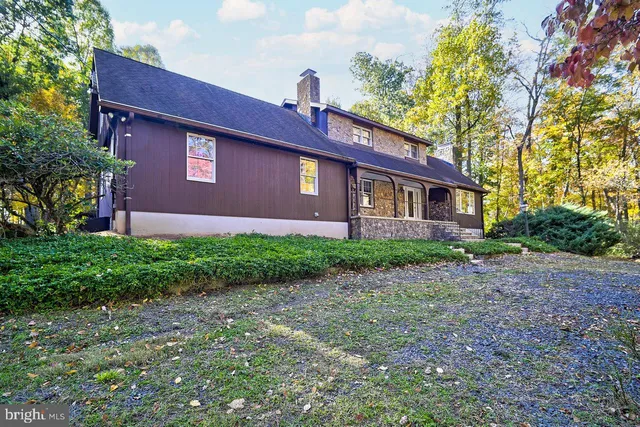 a red brick house with trees in front of it