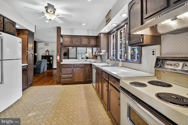 a kitchen with stainless steel appliances a refrigerator and a stove top oven