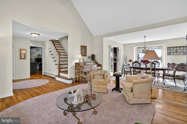 a living room with furniture a fireplace and a table