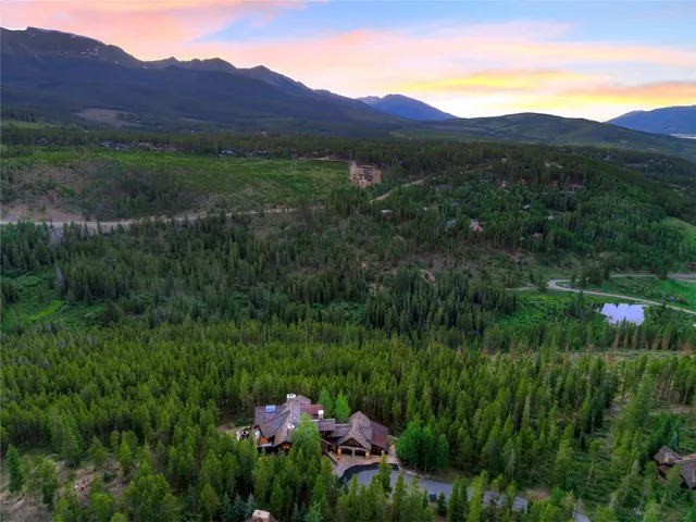 a view of a lush green hillside and a building