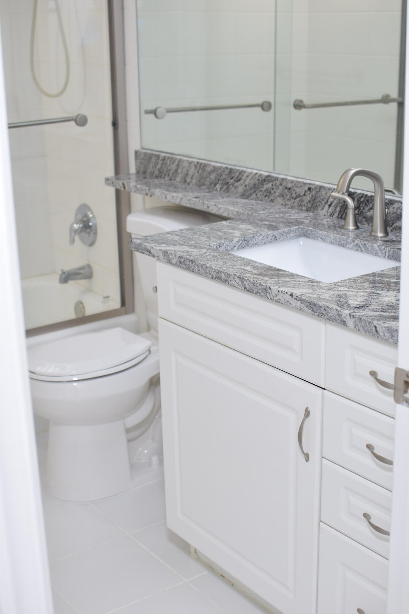 1000 Spanish River Road, Unit 2K Boca Raton, FL 33432 - Photo 13 of 26 a bathroom with a granite countertop sink toilet and shower
