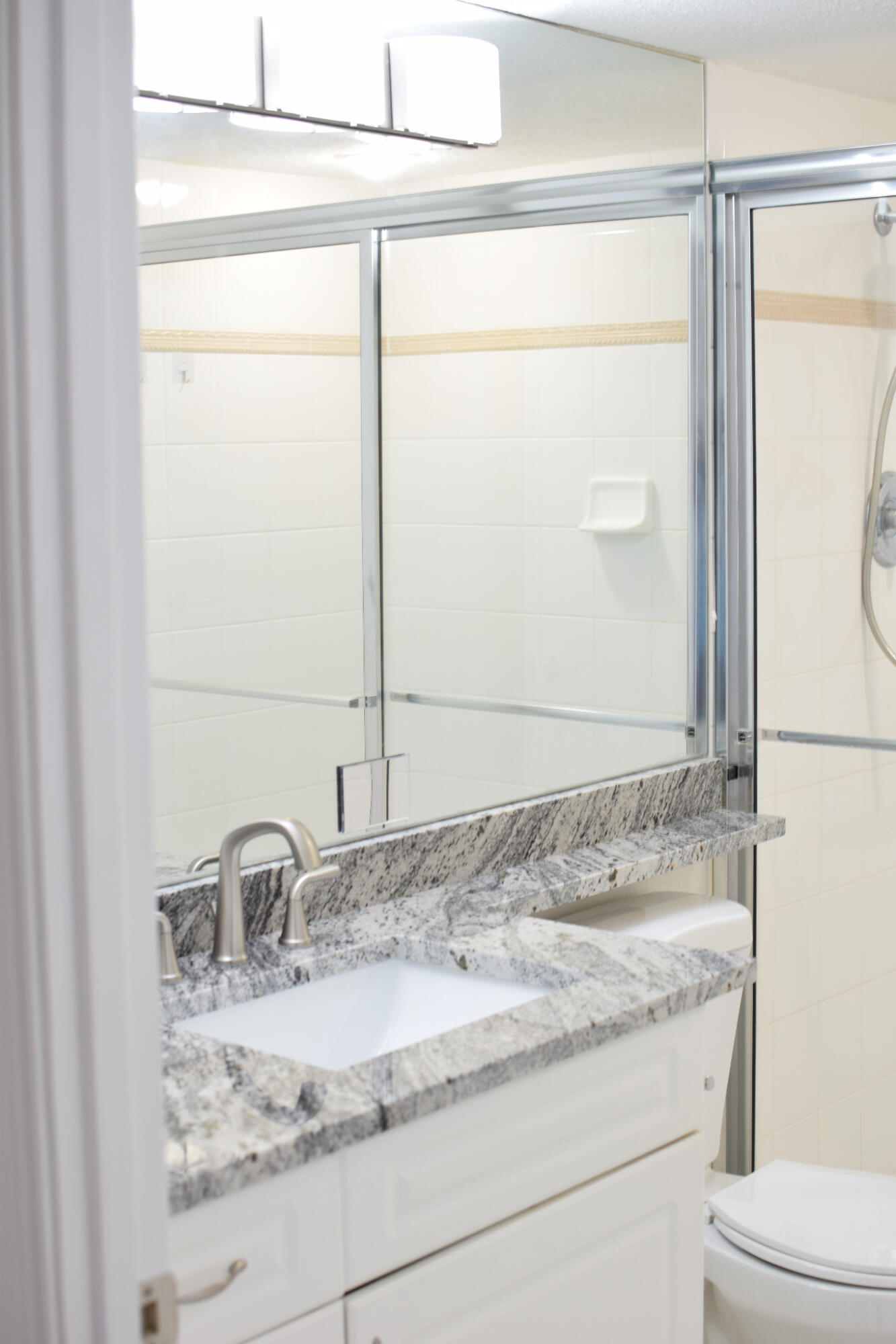 1000 Spanish River Road, Unit 2K Boca Raton, FL 33432 - Photo 15 of 26 a bathroom with a granite countertop sink and a mirror