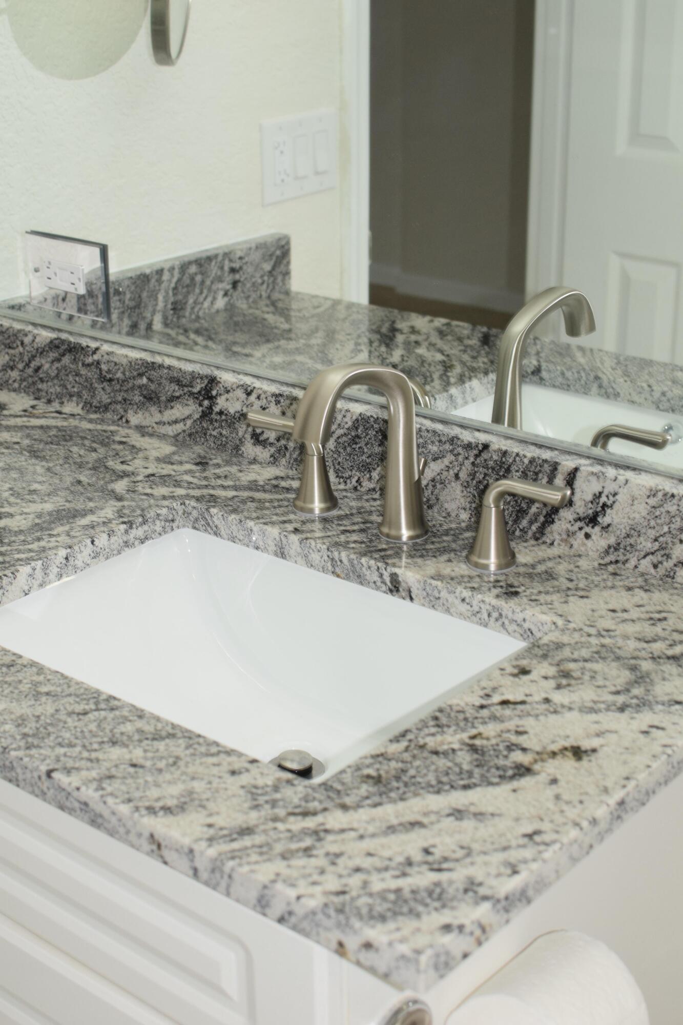 1000 Spanish River Road, Unit 2K Boca Raton, FL 33432 - Photo 16 of 26 a bathroom with a granite countertop sink and a mirror
