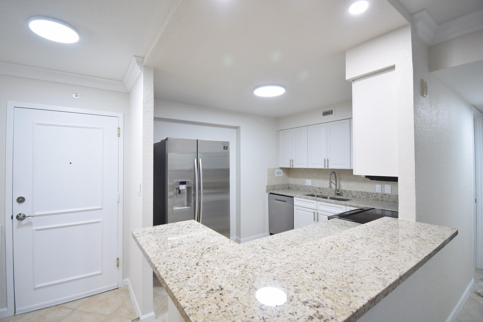 1000 Spanish River Road, Unit 2K Boca Raton, FL 33432 - Photo 9 of 26 a kitchen with a refrigerator sink and stove