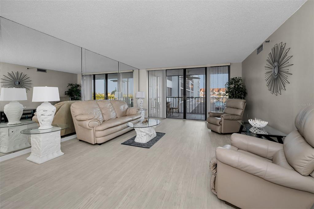 19111 Vista Bay Drive, Unit 211 Indian Shores, FL 33785 - Photo 12 of 62 a living room with furniture and a large window