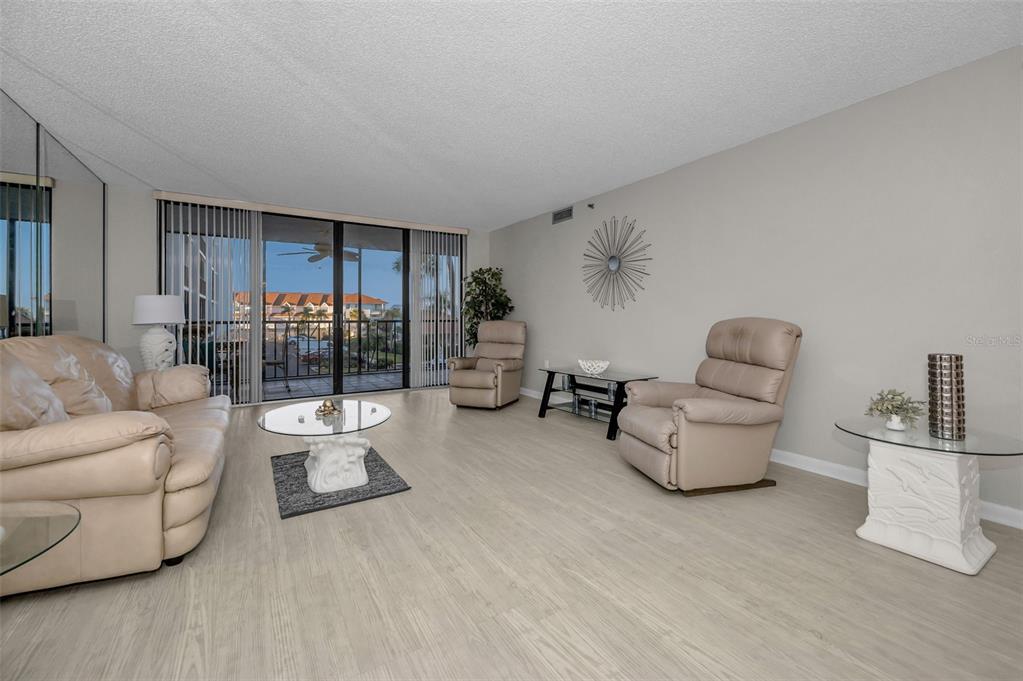 19111 Vista Bay Drive, Unit 211 Indian Shores, FL 33785 - Photo 13 of 62 a living room with furniture and a wooden floor