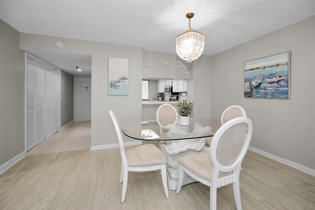 19111 Vista Bay Drive, Unit 211 Indian Shores, FL 33785 - Photo 21 of 62 a view of a dining room with furniture and wooden floor