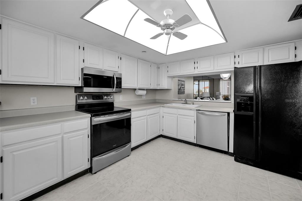 19111 Vista Bay Drive, Unit 211 Indian Shores, FL 33785 - Photo 24 of 62 a kitchen with cabinets stainless steel appliances and a counter space