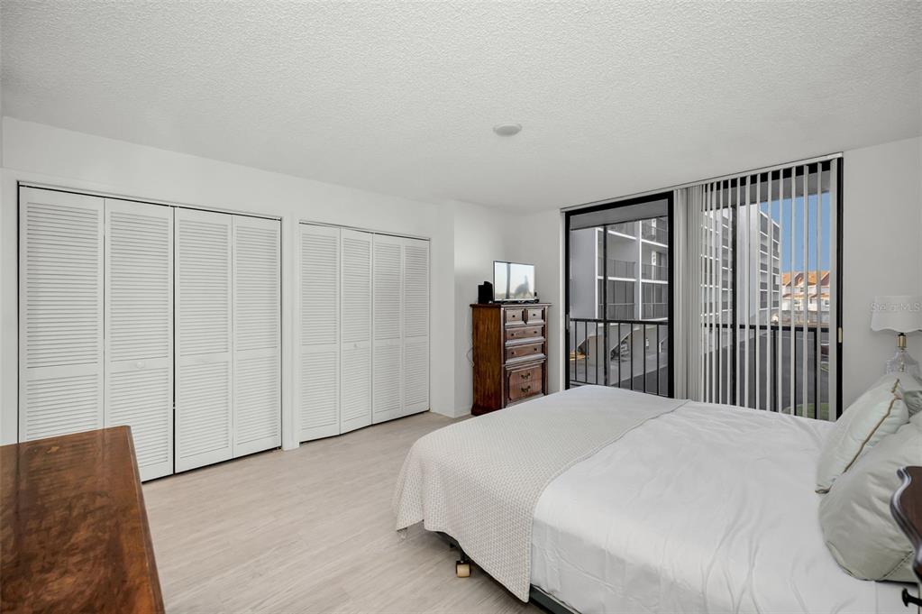 19111 Vista Bay Drive, Unit 211 Indian Shores, FL 33785 - Photo 29 of 62 a bedroom with a large bed and a book shelf