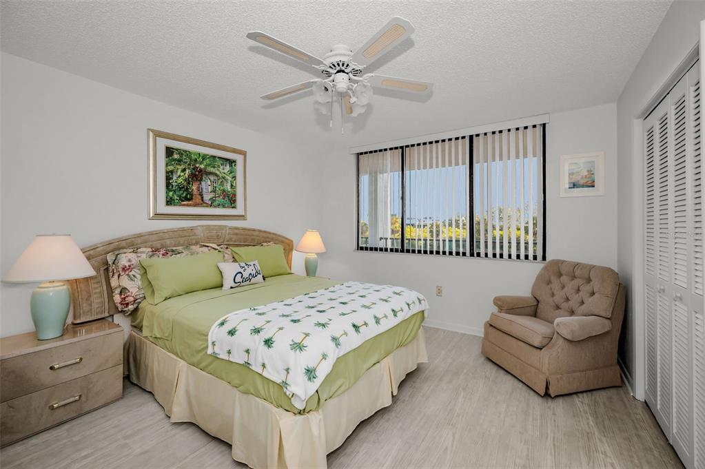 19111 Vista Bay Drive, Unit 211 Indian Shores, FL 33785 - Photo 34 of 62 a bedroom with a bed and a couch