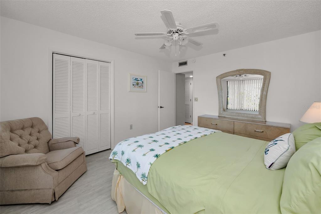 19111 Vista Bay Drive, Unit 211 Indian Shores, FL 33785 - Photo 35 of 62 a bedroom with a bed couches and window