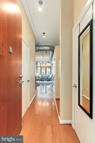a view of a hallway with wooden floor