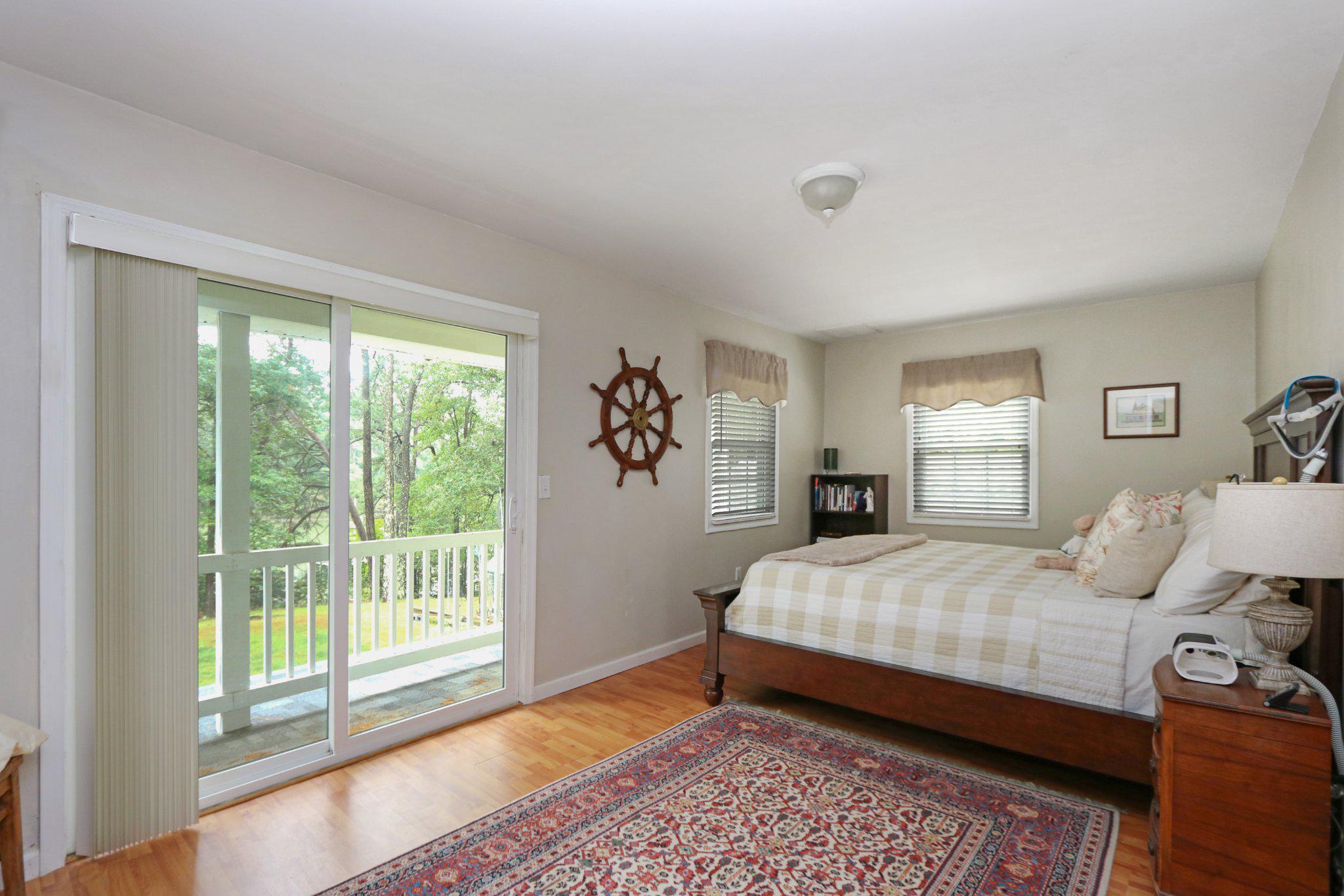 13431 Solitude Trail Machipongo, VA 23405 - Photo 27 of 32 Serene bedroom with nature views.