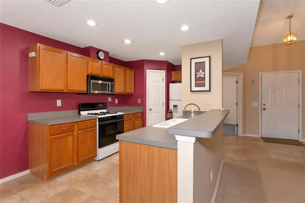 a kitchen with stainless steel appliances granite countertop a stove a sink dishwasher a microwave oven with granite countertops and cabinets