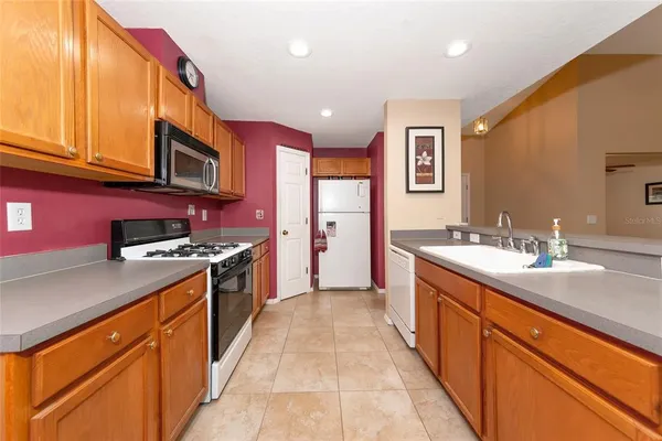 a large kitchen with stainless steel appliances granite countertop a large stove top oven
