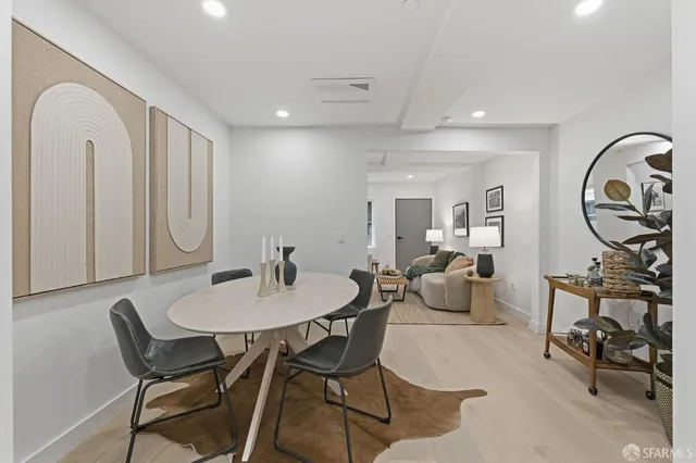 a view of a dining room with furniture and a potted plant