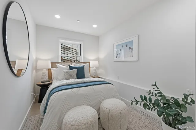 a bedroom with bed and a potted plant