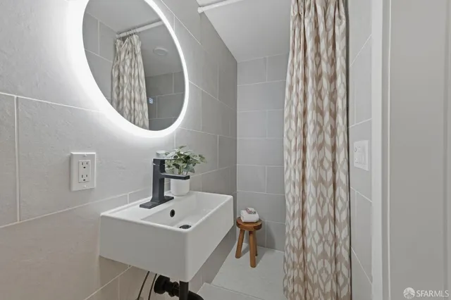 a bathroom with a sink a mirror and a toilet