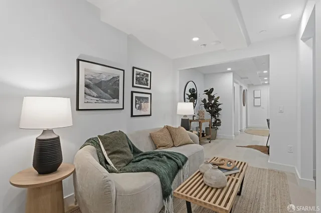 a living room with furniture and a lamp