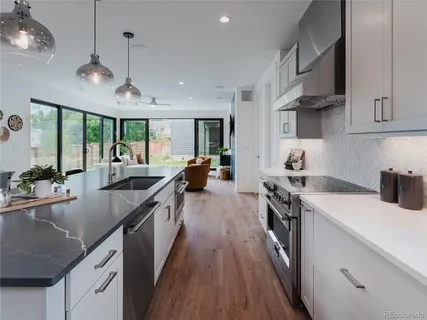 a kitchen with kitchen island a counter space a sink and a stove