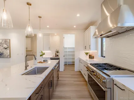 a kitchen with kitchen island a sink stove and cabinets