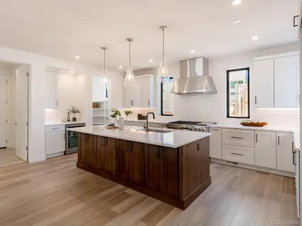 a kitchen with a sink cabinets and wooden floor