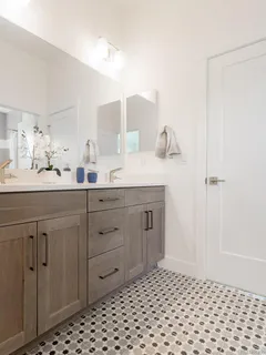 a bathroom with a double vanity sink and mirror