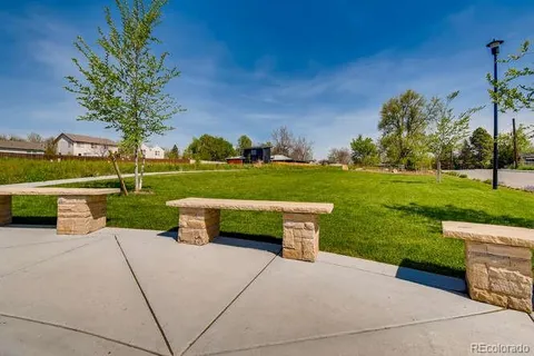 a view of a garden with an outdoor seating