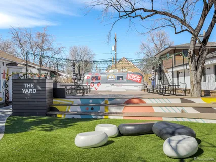 a swimming pool with barbeque oven and outdoor seating