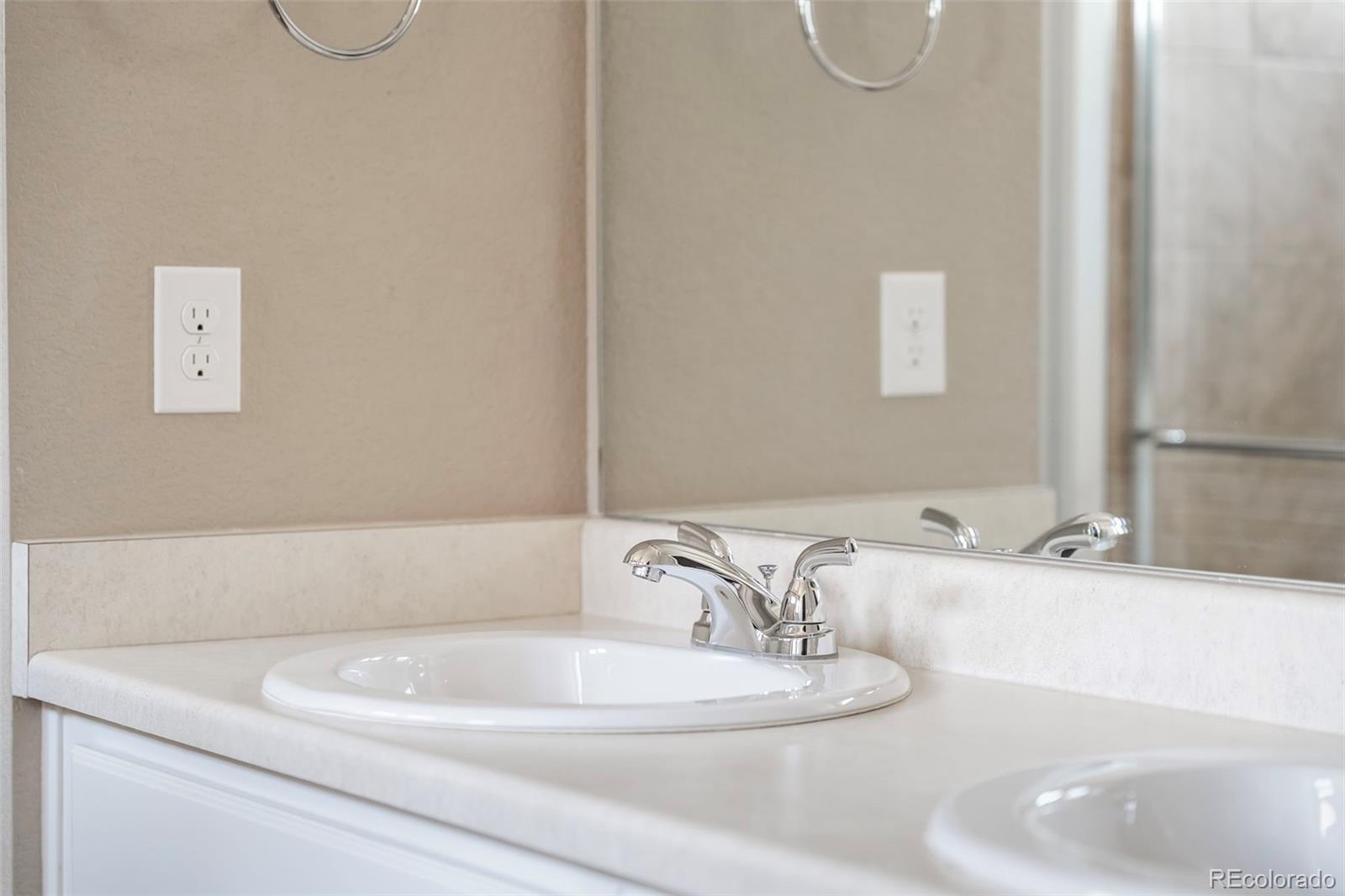 9528 Timberlake Loop Colorado Springs, CO 80927 - Photo 22 of 37 a bathroom with a sink and a mirror