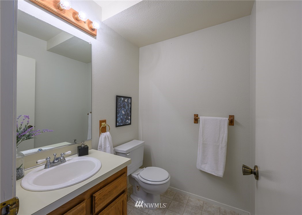 7335 Old Redmond Road, Unit 125 Redmond, WA 98052 - Photo 14 of 15 a white toilet sitting next to a bathroom sink and vanity