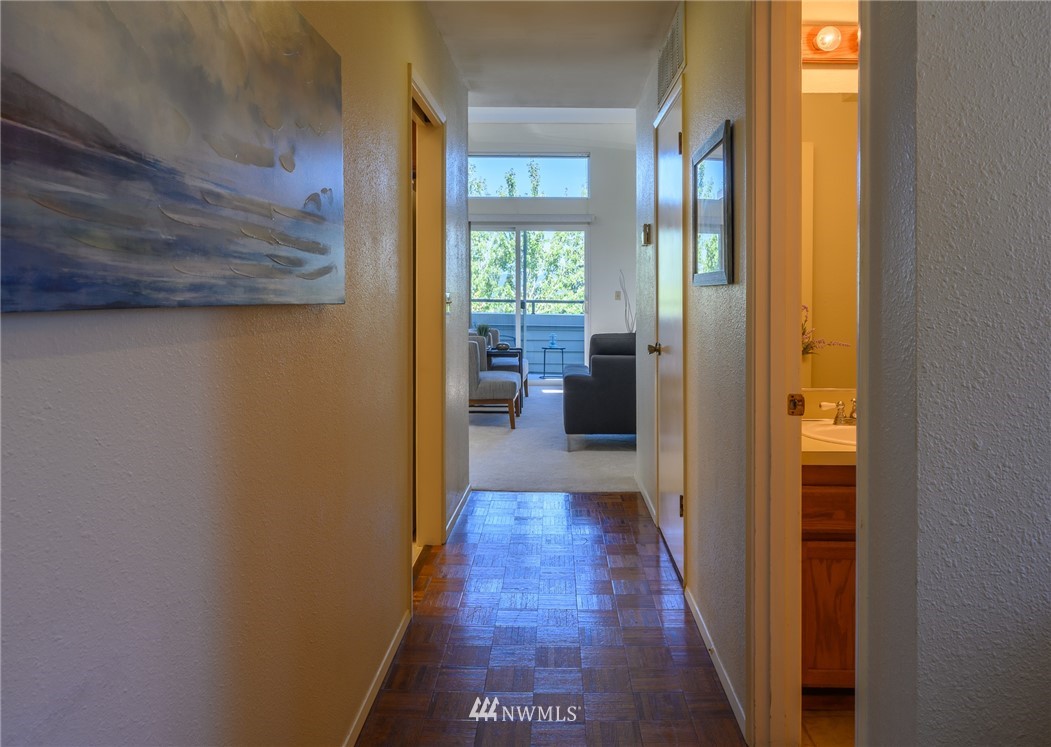 7335 Old Redmond Road, Unit 125 Redmond, WA 98052 - Photo 15 of 15 a view of a hallway with wooden floor and a living room