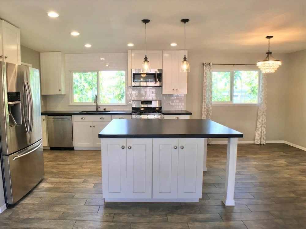 6391 Puupilo Road, Unit B Kapaa, HI 96746 - Photo 29 of 30 a kitchen with kitchen island granite countertop a sink a counter space appliances and cabinets