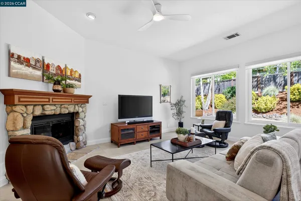 a living room with furniture fireplace and window