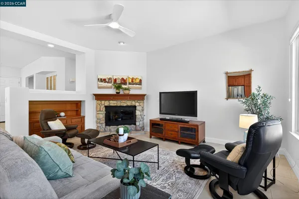 a living room with furniture a fireplace and a flat screen tv