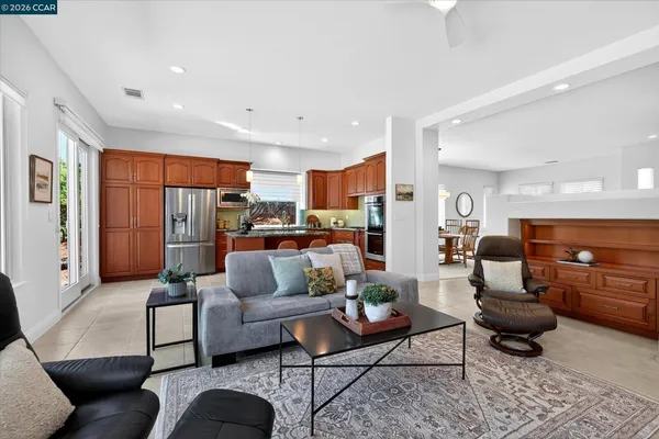 a living room with furniture and kitchen view