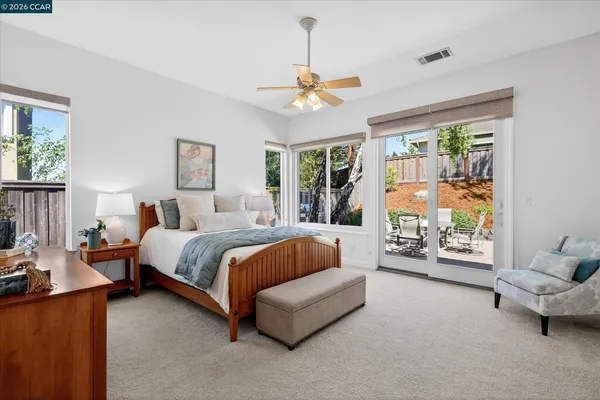 a spacious bedroom with a bed couch and a window