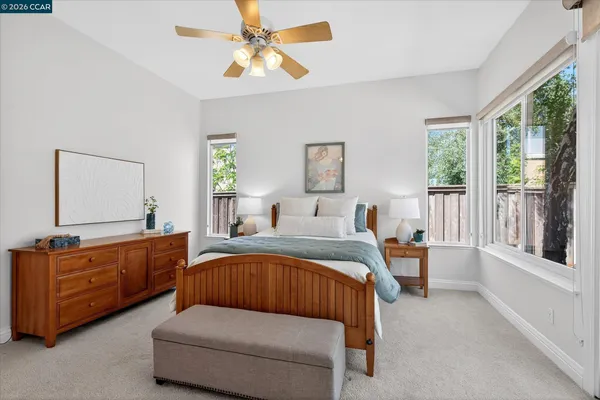 a bedroom with furniture and large windows