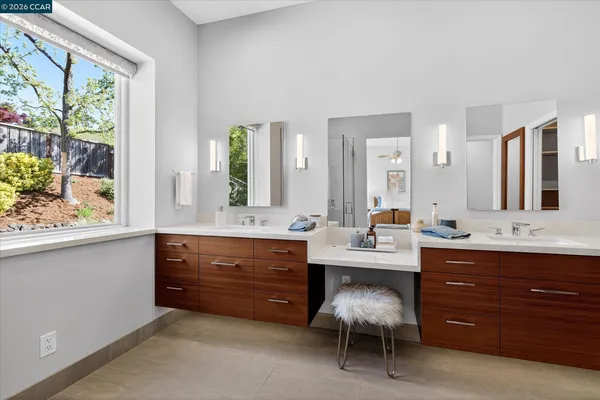 a room with a table chairs and a large window