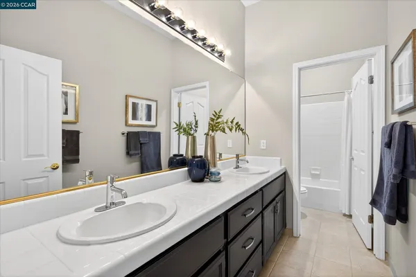 a bathroom with a sink double vanity and a mirror
