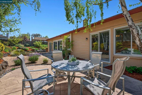 a view of a patio with a table and chairs