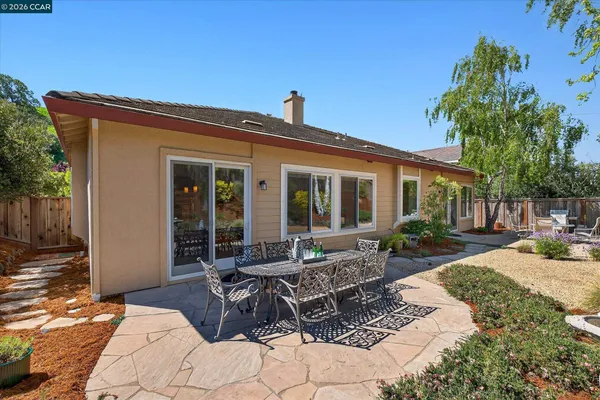 a view of a house with backyard sitting area and porch