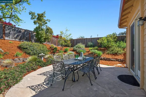 a view of an outdoor space with a table and chairs