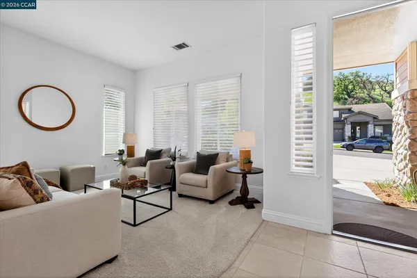 a living room with furniture and a floor to ceiling window