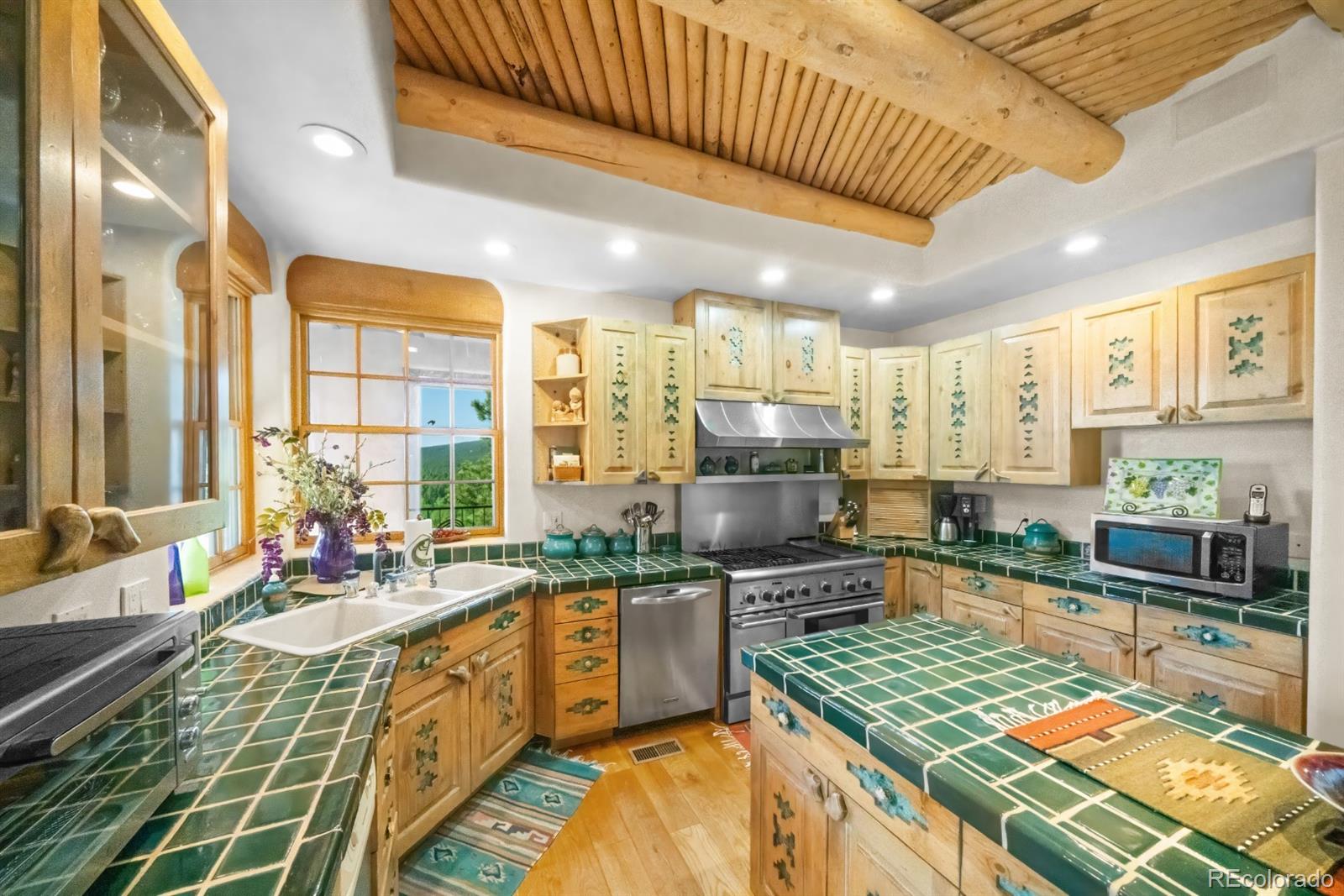 8221 Cuerna Verde Road Rye, CO 81069 - Photo 12 of 50 a kitchen with stainless steel appliances lots of counter top space and a stove