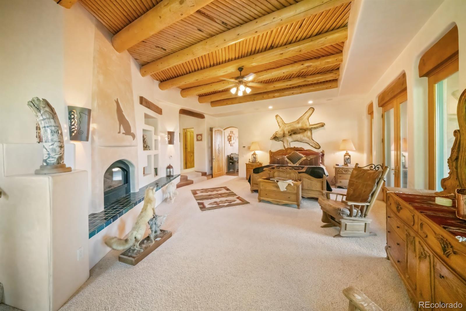 8221 Cuerna Verde Road Rye, CO 81069 - Photo 18 of 50 a living room with furniture a fireplace and a chandelier