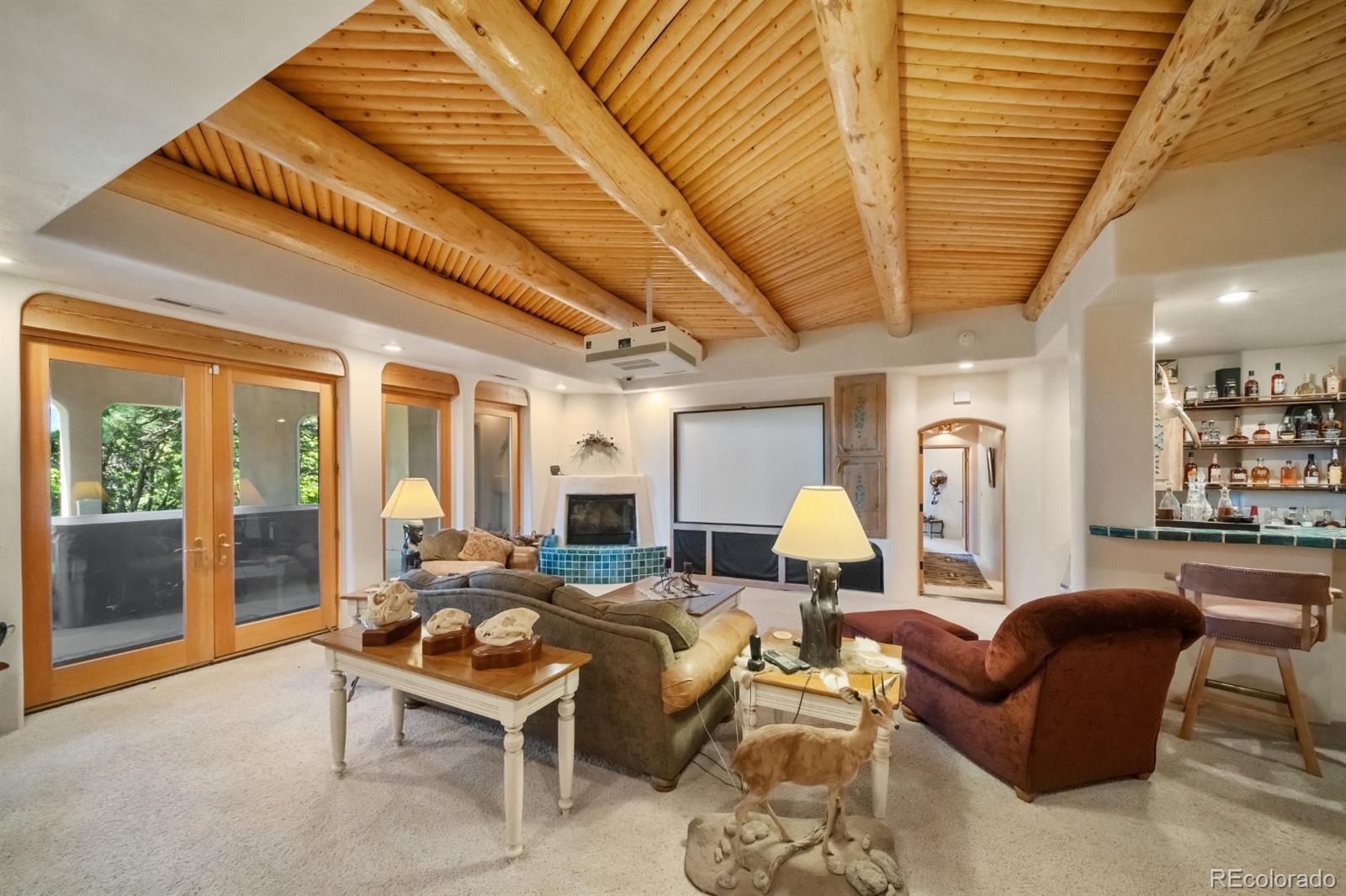 8221 Cuerna Verde Road Rye, CO 81069 - Photo 32 of 50 a living room with furniture a fireplace and a large window
